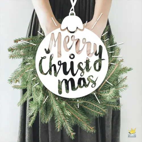 Merry Christmas image with woman holding a branch from a Christmas tree.